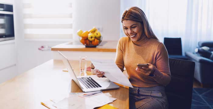 lady paying bills on phone and computer