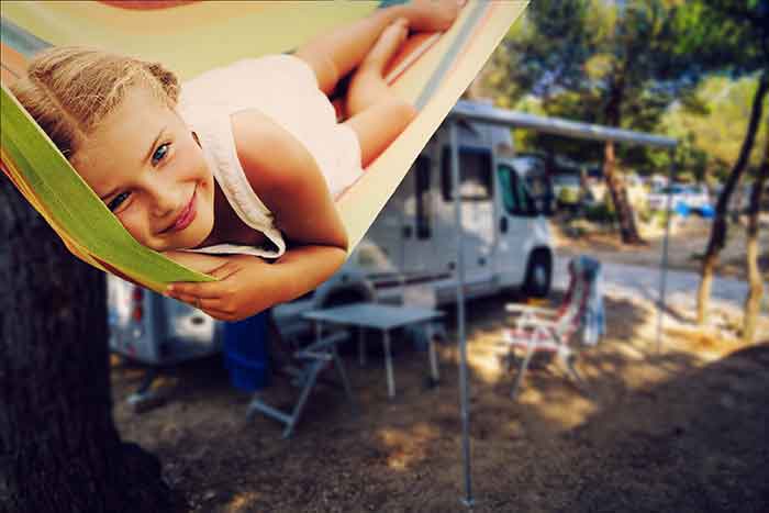 child in hammock rv in background