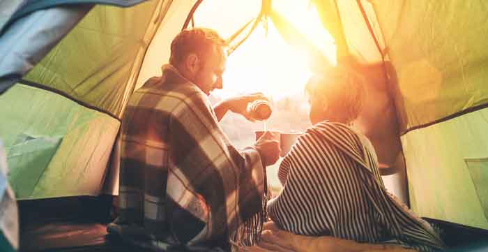 father and son camping in a tent