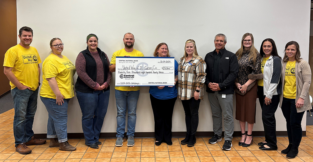 central national bank employees and united way representatives holding a large check for donation