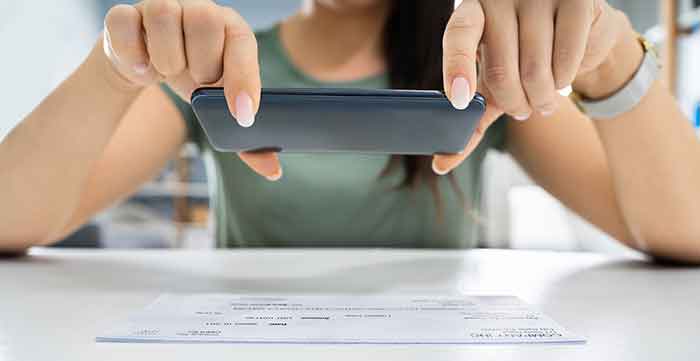 woman depositing a check using her phone