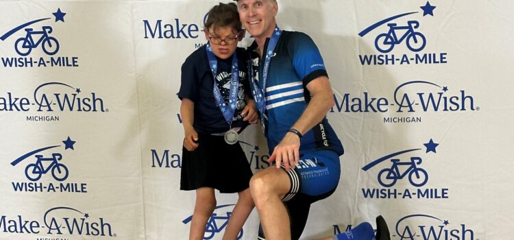 Joe Karnes with child at Make-a-Wish Michigan